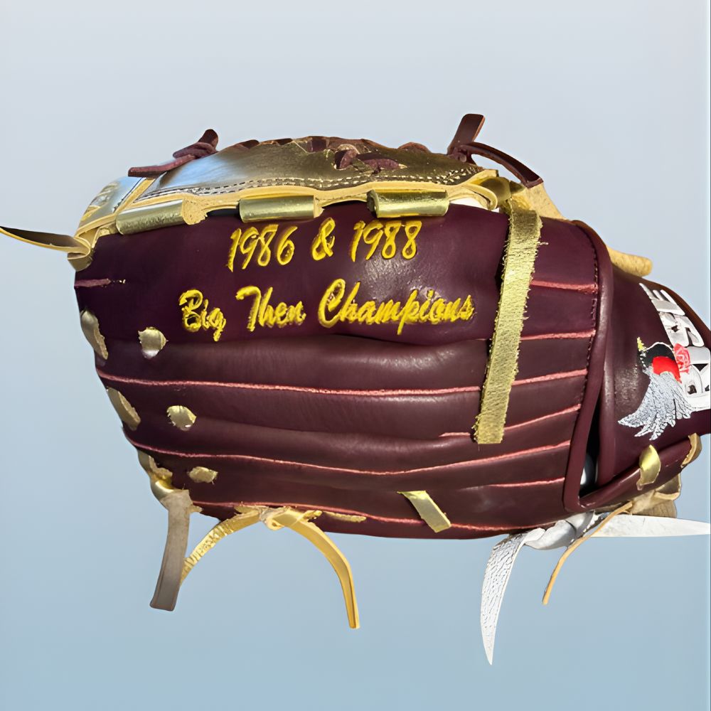 Custom RISE softball glove in maroon and gold featuring a two-piece modified web and personalized player embroidery.