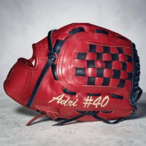 Side view of a RISE custom red leather softball glove featuring white embroidery 'Adri #40'.